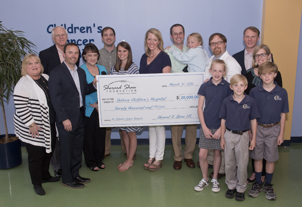 Members of the Shaw, Branning, and Dale families were on hand for the presentation of the Sherard Shaw Foundation’s first gift to Children’s Hospital.  The gift was given in memory of Coach Scott Branning and Campbell Dale, both of whom battled cancer.  The group gathered to honor the inspiring spirit of both Branning and Dale, and also to further Coach Sherard Shaw’s wish that all children have the best future possible. From left to right are Tina Shaw, Keith Branning, Bubba Shaw, Carol Branning, Jeremy Rowan, Sarah Margaret Rowan, Jill Dale, David Dale (holding Avery Dale), Dr. Anderson Collier, Jason Branning, Mary Kelly Branning, and Meg, Benjamin, and Charlie Branning.