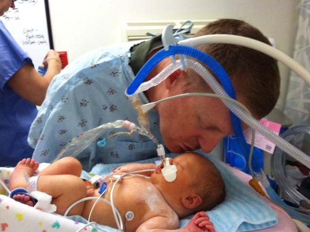 Sybil Cumberland gets a kiss from father Jason Cumberland during her stay at UMMC.