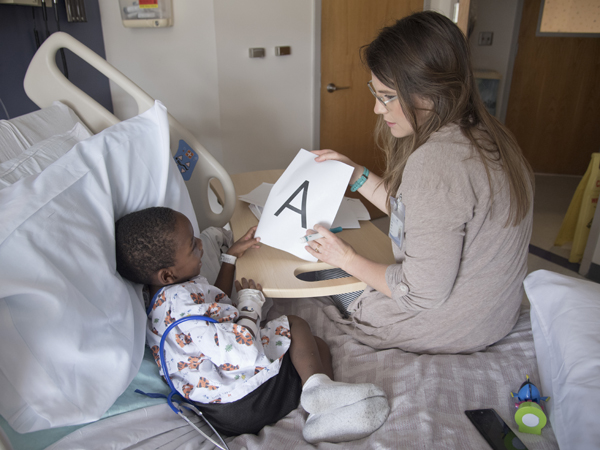 Marion Williams of Magee learns his letters from Hospital School teacher Kristy Gandy.