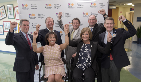 Celebrating the announcement are, seated, Ray and Woodward; and, standing, from left, Barr, board member Sidney Allen, board president Rob Armour, board member Bruce Leach and Children's of Mississippi CEO Guy Giesecke.