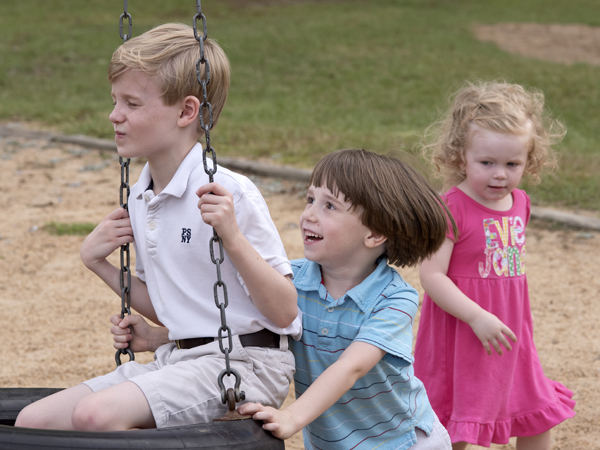 Fraiser plays with his brother and sister at Strawberry Patch Park in Madison.