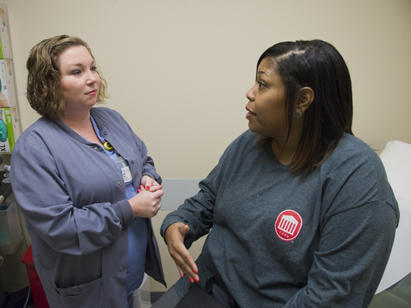 King chats with Pegues during a check-up visit at UMMC