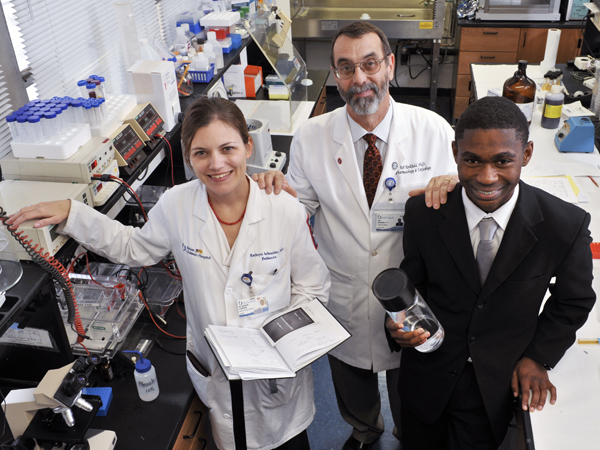 Dr. Kathryn Schneider, left, assistant professor of pediatrics, Dr. Rob Rockhold, center, director of the Base Pair program, and Murrah Senior Justin Porter celebrate the 20-year Anniversary of Base Pair in 2011.