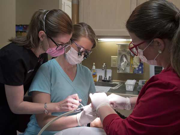 Jamie Hargett Howard, center, was in the first round of students to take part in the CODE program. She was hosted in the Raleigh clinic of Dr. Stephanie Tullos, left, who is being assisted by Amanda Sullivan, right.