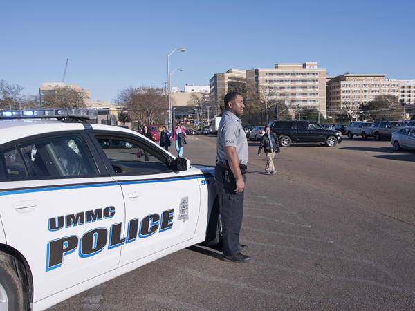 Officer Sean Jackson watches over the stadium parking lot as employees leave work at 4:30.