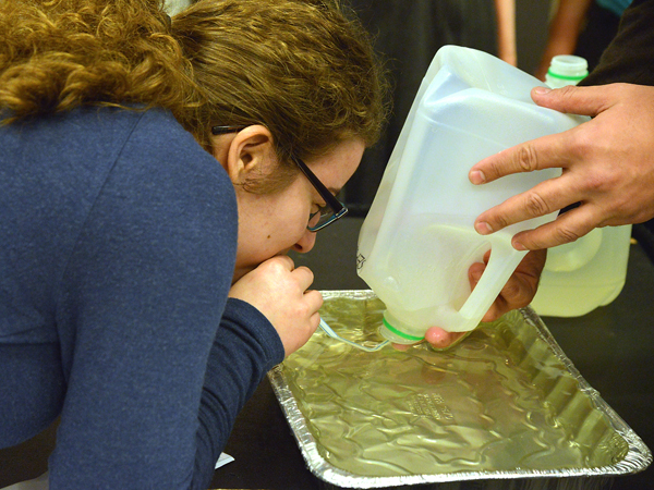 Krista Syrigos, a junior at Belhaven, takes a deep breath to measure her maximal breathing volume with the assistance of UMMC's Dr. Eric George.