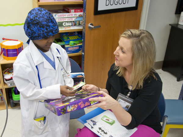 Robinson exchanges his hard-earned BMT Bucks for a toy in Batson Children's Hospital's BMT Bucks store.