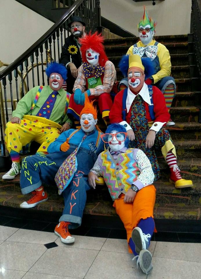 UMMC director of perioperative services Chip Thomason (right, with large tie and yellow visor) sheds his medical garb and puts on his clown clothes for rodeos and parades.