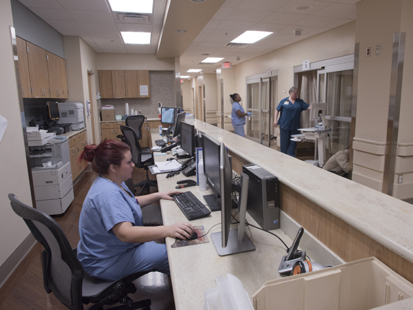 Meredith Worley, a registered nurse at the Women's Urgent Care Center, takes advantage of the center's newly designed work areas.