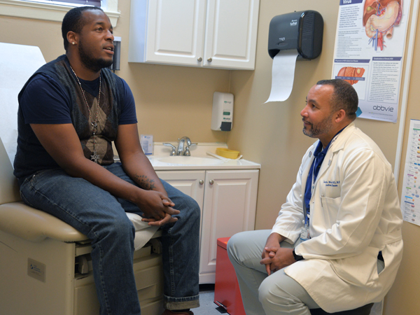 Brazzle talks with Mena during a clinic visit.