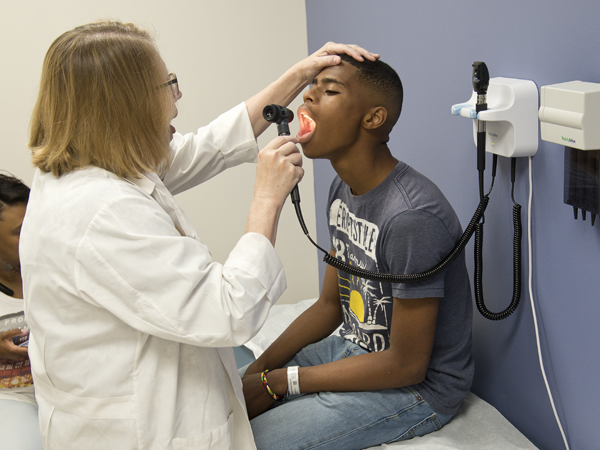 Weisenberger examines patient Javorrius Bennett.