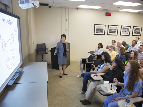 Luzuriaga gives a history of the "Mississippi Baby" case during pediatric grand rounds Wednesday.