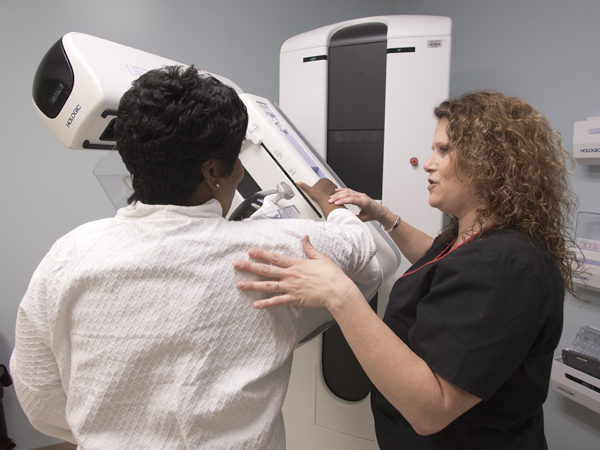 Tammy Williams, a mammography technologist at the Breast Imaging Center, walks Smith of Clinton through the new 3D mammography procedure.
