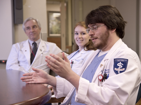 Dr. Thomas Skelton Sr. and daughter Dr. Charlotte Skelton Taylor listen as Thomas Skelton Jr. discusses life as a medical student.