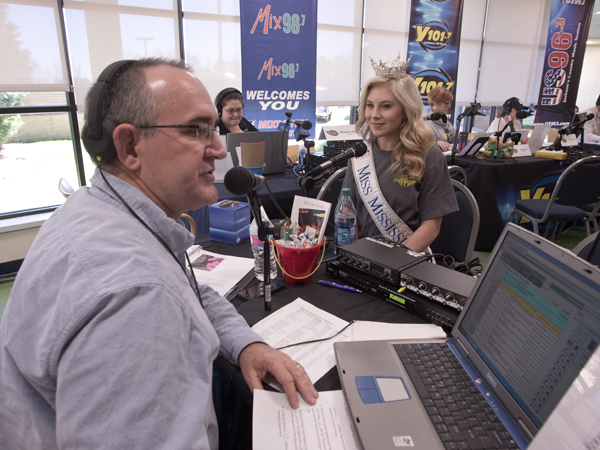 Mark McCoy, an on-air personality for 100.9 The Legend, interviews Miss Mississippi Hannah Roberts during the Mississippi Miracles Radiothon.