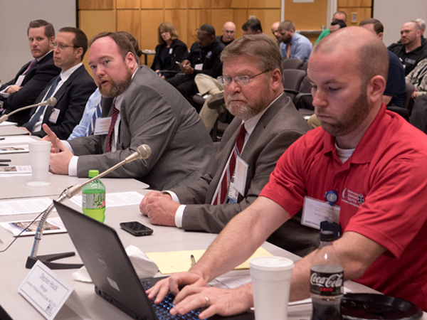 Jonathan Wilson, center, chief administrative officer, replies to a statement by a Magnolia Thunder participant.