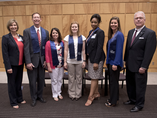 Five finalists were chosen from the Nelson Order inductees to compete for the TEACH Prize. Pictured from the left are Vice Chancellor LouAnn Woodward; William P. Daley, M.D., School of Medicine; Kim Douglass, M.S.N., School of Nursing; Jennifer Bain, D.M.D., School of Dentistry; Juanyce Taylor, Ph.D., School of Health Related Professions; Bridget Chisolm, Pharm.D., School of Pharmacy; and Alon Bee, Regions Bank city president of metro Jackson.