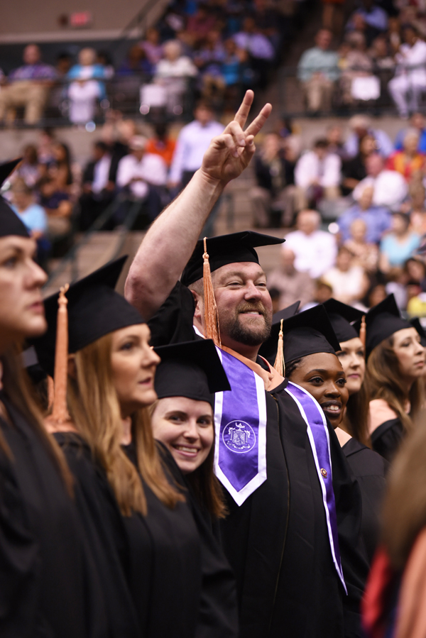 Lonnie Moore of Crowder, a master of science graduate in the UMMC School of Nursing celebrates earning his degree.