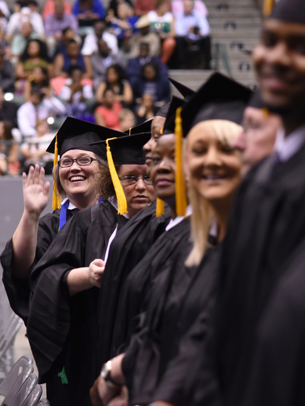 A new UMMC graduate gives friends and family a wave.