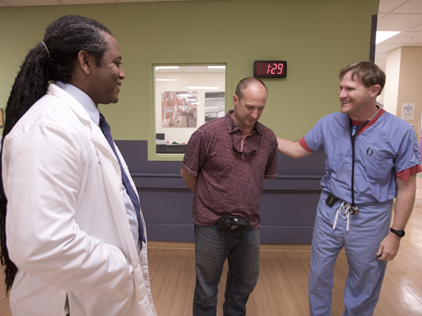 Holder reminisces with Dr. Cameron Guild, right, associate professor of cardiology. They're among UMMC doctors who helped save the life of heart attack patient Lindsey.