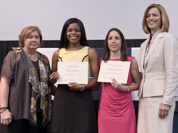 From the left are Vandergriff and scholarship winners Macy Lagarde and Florencia Carden with Hoover.