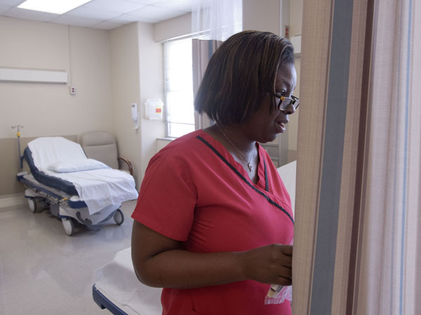 Wilson checks on a patient receiving fluids and medications in UMMC's sickle cell day clinic.