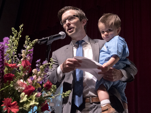 Dr. Peter Mittwede hold his son Isaac as he reads his match during the 2016 Match Day ceremony.