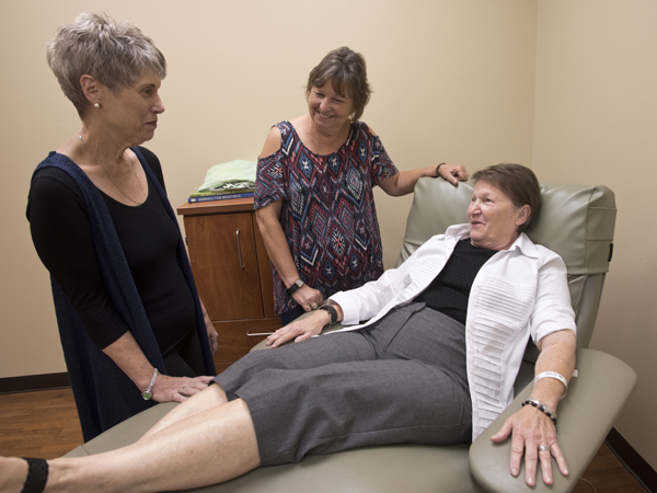 Hankins, seated, visits with friend Brenda Scafidi, left, and sister Beverly Sinele before her PET scan at the Jackson Medical Mall.