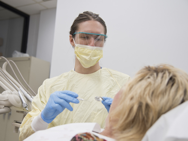 Sistrunk's "real job" is to care for patients in the clinic as he finishes his dental degree.