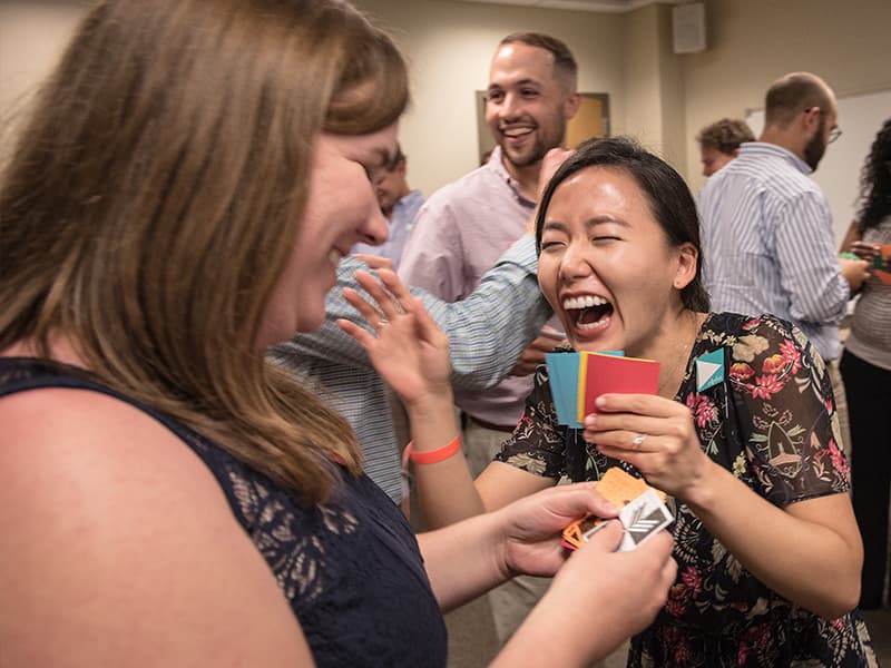 First-year dental student Audrey Fortin, right, responds exuberantly to classmate Sarah Stonefied during Bafa Bafa, an exercise that promotes awareness of cultural differences.