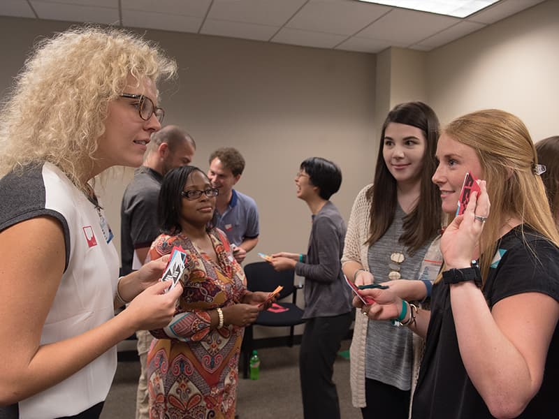 First-year dental students, from left, Kalin McCate Roach and Jaleesa Dandridge work with their medical student counterparts, Alexis Mason and Anna Britt, in a training exercise known as Bafa Bafa, which is  designed to increase awareness of cultural differences.