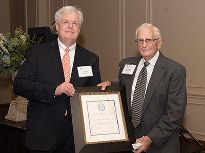 Moore accepts his certificate from Longest.