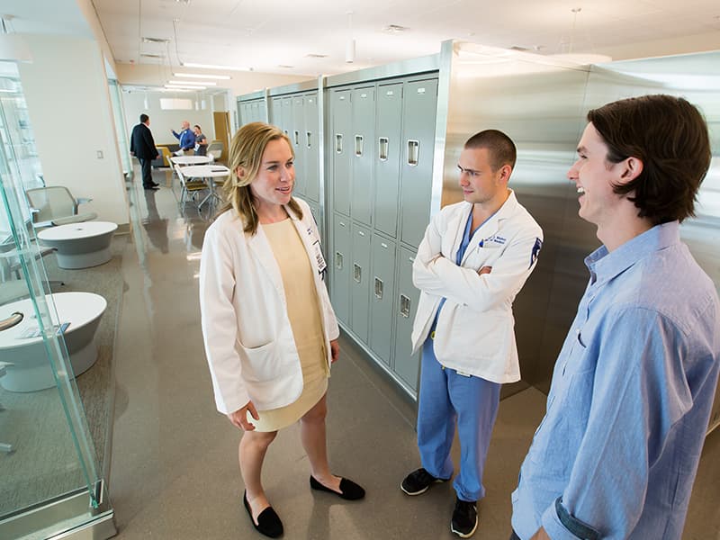 Third-year medical student Laura Lee Beneke, left, fourth-year medical student Taylor Mabry, center, and first-year medical student Kirby Parker chat inside a student lounge inside the new School of Medicine.