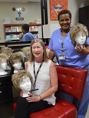 UMMC Public Affairs assistant director of media relations, Ruth Cummins and her siblings donated 10 wigs that had belonged to her mother, who died of liver cancer last year. Janice Johnson, manager of the Cancer Institute Patient Resource Center, oversees the wig room.