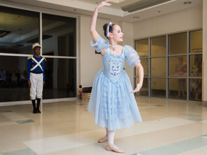 Ballet Mississippi's Emma Butler dances as a girl doll during a scene from "The Nutcracker." Looking on is dancer Wilton McDowell, dancing the role of a soldier doll.