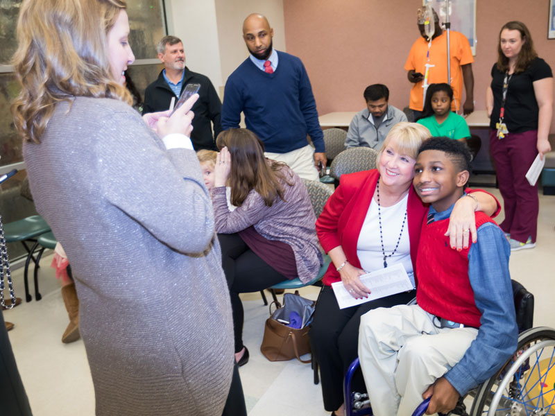 Kelly Scrivner snaps a photo of Mississippi First Lady Deborah Bryant and Batson Children's Hospital patient K.J. Fields, who lit the hospital Christmas tree during BankPlus Presents Light A Light. The event, the oldest of Friends of Children's Hospital fundraisers, is the traditional start of the holiday season at UMMC.