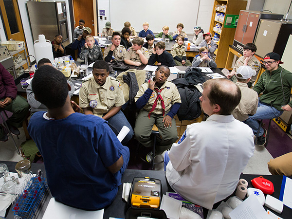 Sanders and Case explain where and how to take a pulse to Jackson-area Boy Scouts.