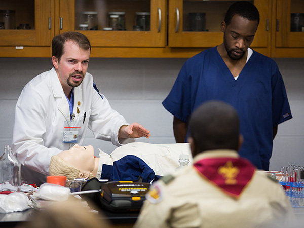 Case and M2 Dennis Sanders teach CPR to Boy Scouts.