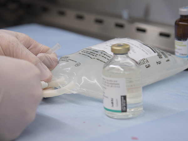 Harrison prepares an IV bag.