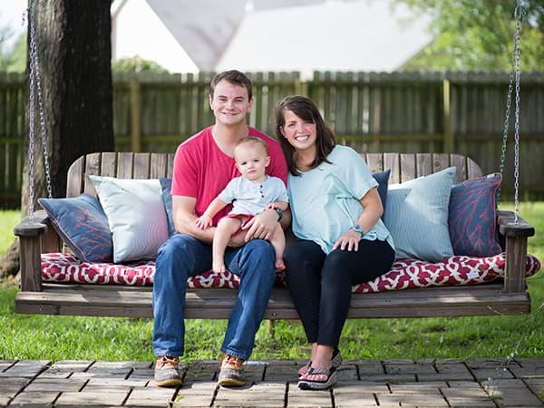 Miles Backtrom's woodworking creations range in size from small to large, like this pergola and swing that he enjoys with his wife Laura and their son Bennett at their home in Madison. Daughter Lottie Leigh was born on June 30, not many days after this photo was taken.