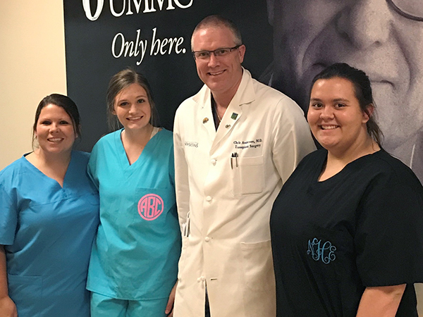 Dr. Christopher D. Anderson, professor and chief of transplant surgery who arranged the scholars’ visit to UMMC, talks with, from left, Price, Blaylock and Howell.