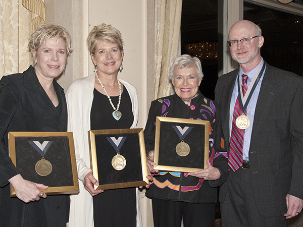 Dr. Tom Mosley, right, recipient of the Dudley and Robbie Hughes Distinguished MIND Center Chair, and Hughes family members, from left, Cindy Hughes Meehl, Vikki Hughes and their mother, Robbie Hughes, receive medallions during the April 14, 2015 ceremony to announce the awarding of the new chair.