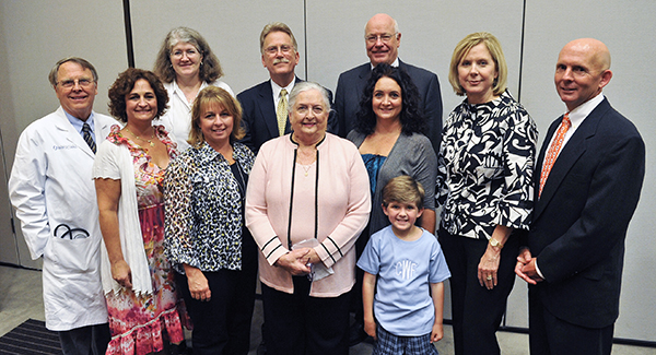 Dr. Gailen Marshall, fifth from left, receives the R. Faser Triplett Sr. M.D. Chair of Allergy and Immunology during a 2012 ceremony at the Norman C. Nelson Student Union. Medical Center representatives and members of the Triplett family on hand include, from left, Dr. Richard deShazo, Suzy Fuller, Dr. Shirley Schlessinger, Lou Ann Woidtke, Jackie Triplett, Dr. Jim Keeton, Liz Walker, Felton Walker, Susan Triplett and Chip Triplett.