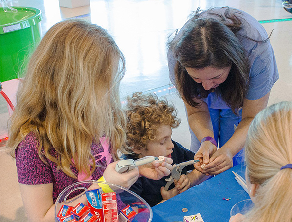 Mari Ashlyn and Carter Griffin get a lesson in dentistry from Fawad.