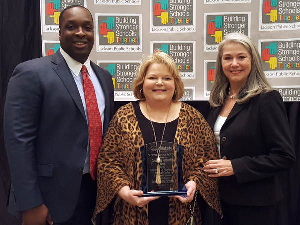 Tammy Dempsey, center, Office for Community Engagement and Service Learning director, and Dr. Janet Harris, professor of nursing and associate dean for practice and community engagement, receive the Steven James Allstate Award on behalf of UMMC from James, an Allstate agent.