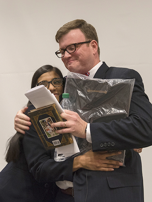 STAR Lisa Biswas presents a plaque of recognition and a copy of Randy Pausch's The Last Lecture - signed by all of the STARs - to Ingram.