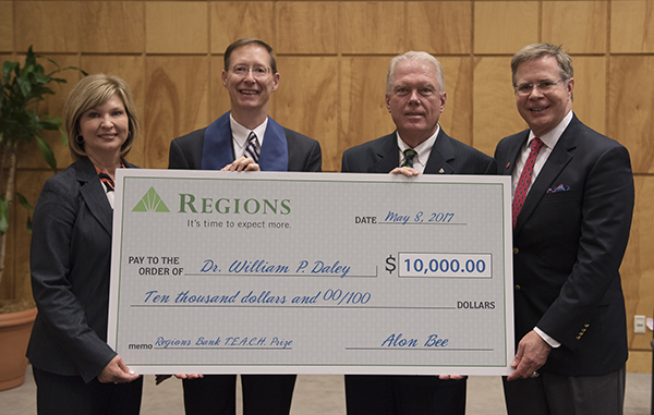 Congatulating Daley, second from left, on his teaching accomplishment are, from left, Dr. LouAnn Woodward, vice chancellor for health affairs; Bee; and Dr. Jeffrey Vitter, University of Mississippi chancellor.
