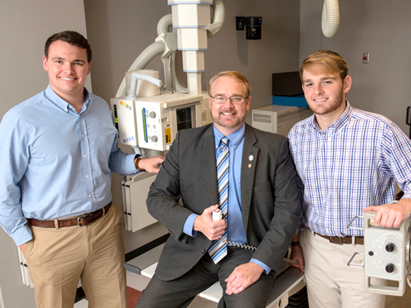 Dr. Mark Gray, center, said he is proud that his sons have followed in his footsteps.