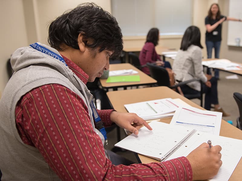 Shamsed Mahmud takes notes during a class on statistical inference.