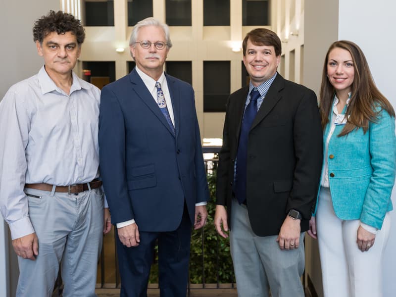 Patent recipient Dr. Drazen Raucher, left, and Dr. Lee Bidwel, second from right, with Summers and Musshafen.